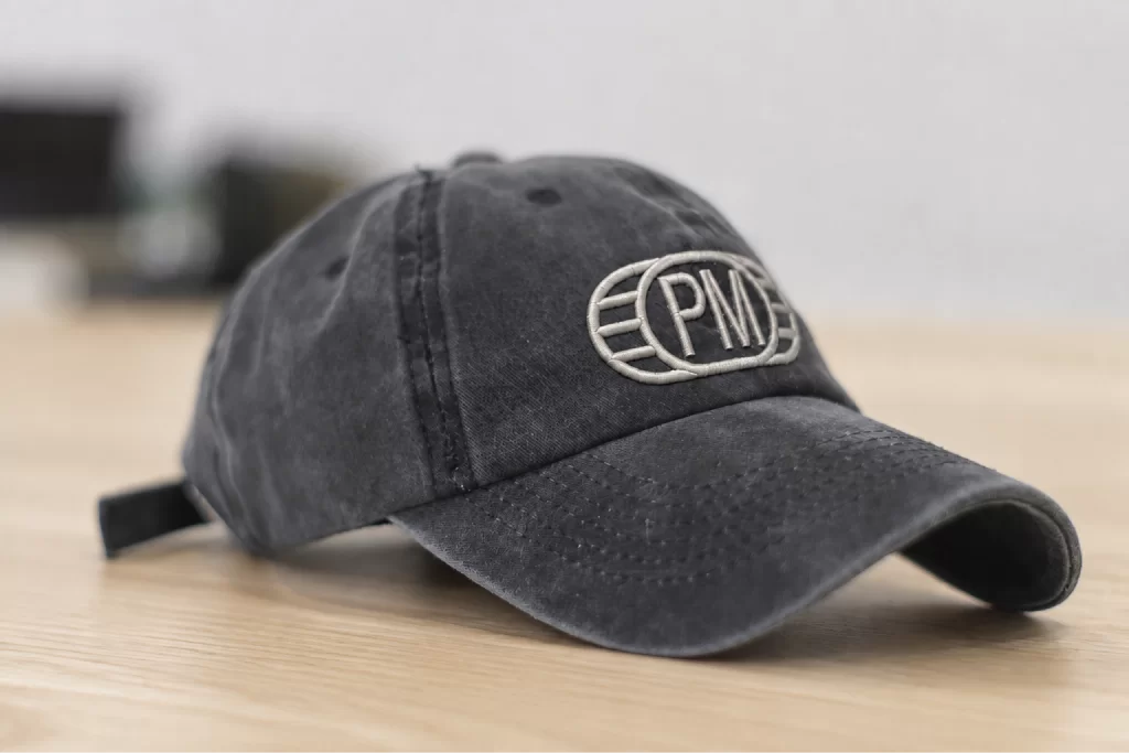 Washed-black cap embroidered with the PM monogram