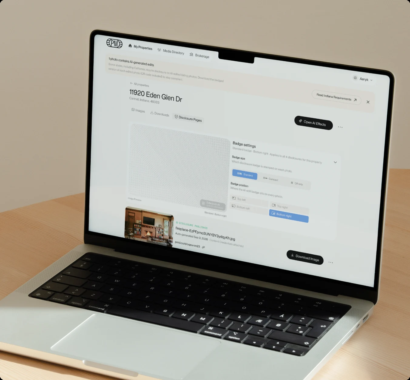 Laptop on a wooden desk showing a property’s disclosure badge settings in PropMedia